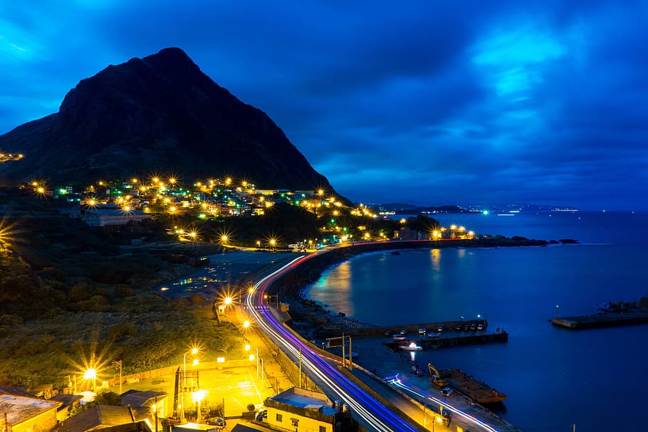 time-lapse photography, road, nighttime, bay, mountain, coast, shore, ocean, sea, town