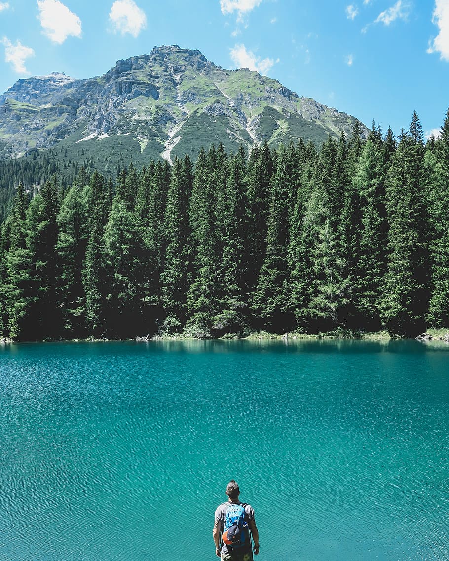 man, facing, body, water, trees, front, mountain ridge, standing, lake, nature