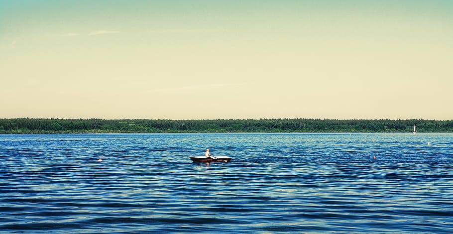 person rowing, boat, brown, canoe, body, water, daytime, sea, ocean, blue
