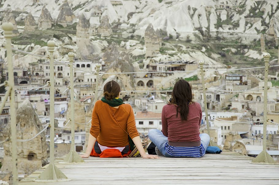 two, women, sitting, dock, people, rock formations, fairy chimney, nevsehir province, cappadocia, goreme