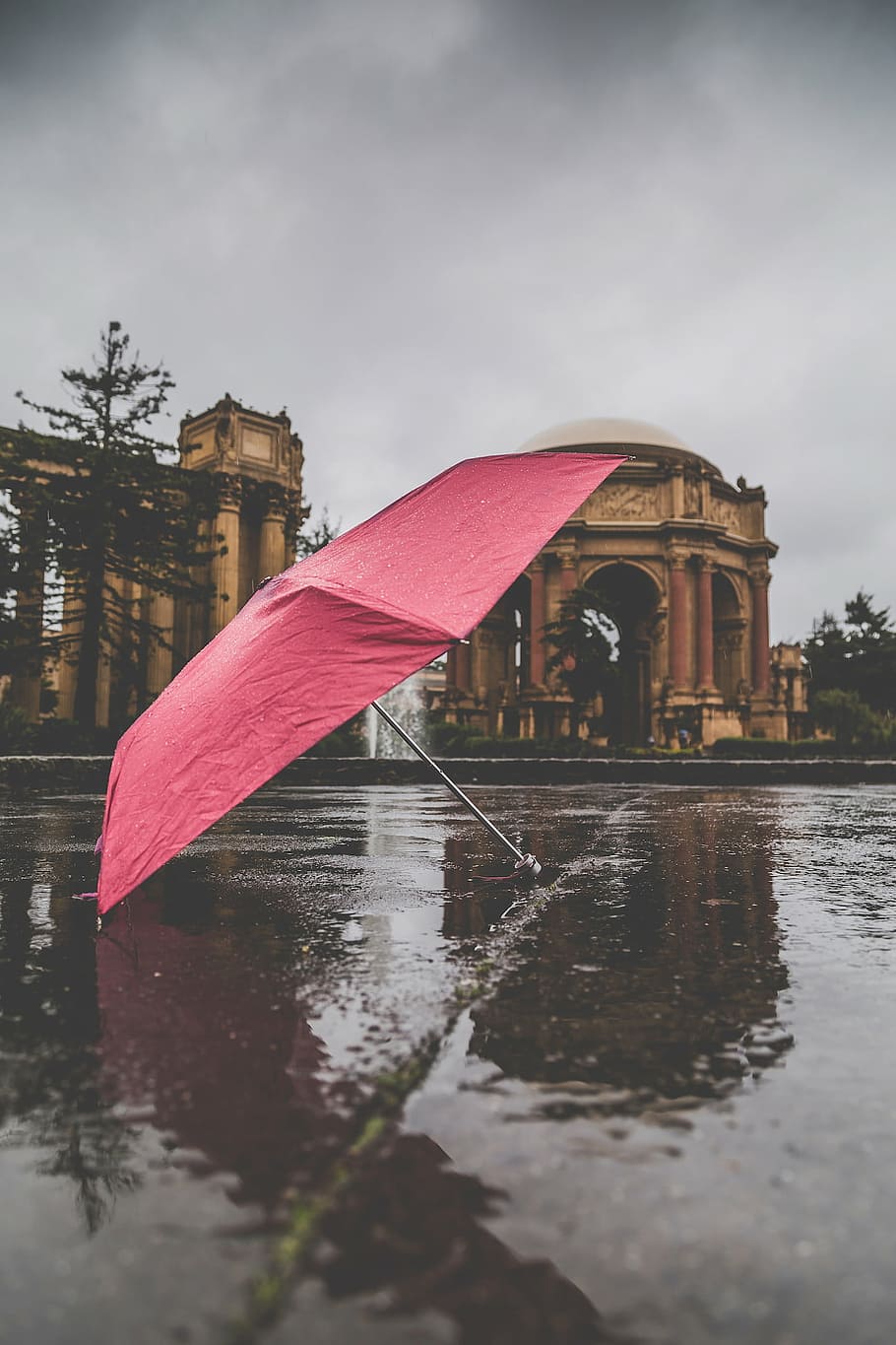 red, umbrella, wet, ground, rain, architecture, structure, road, sky, water