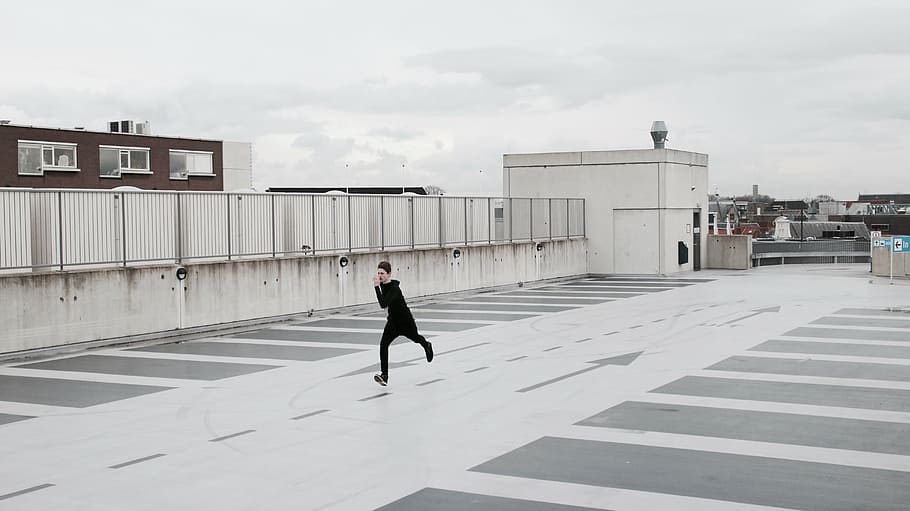 man, running, rooftop, architecture, building, structure, sky, cloud, street, lane