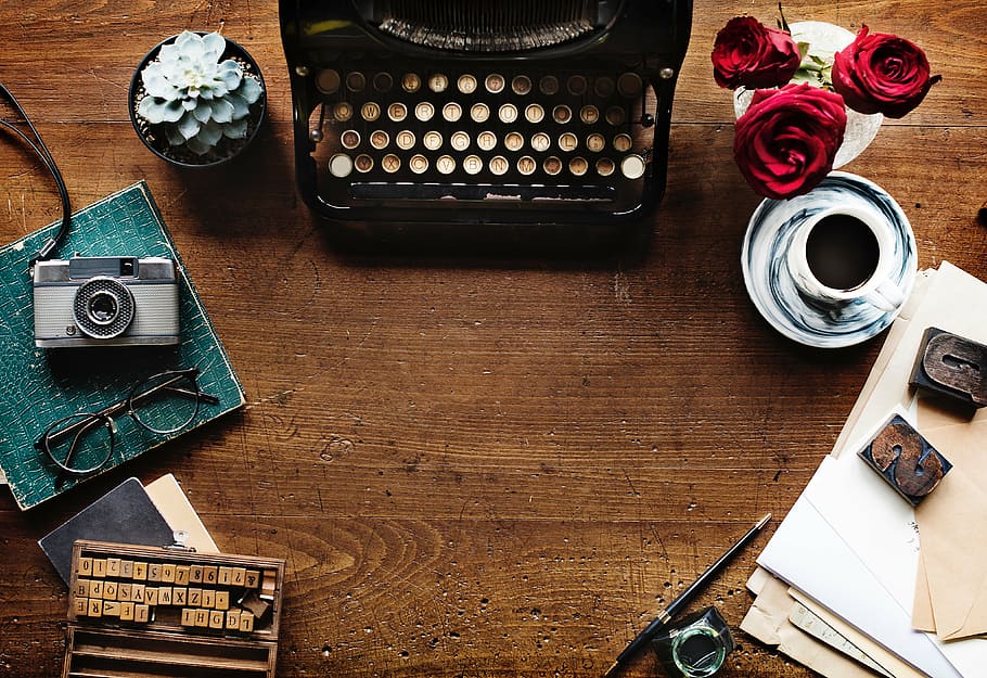 layout photography, black, typewriter, camera, succulent, plant, roses, vase, wooden, table