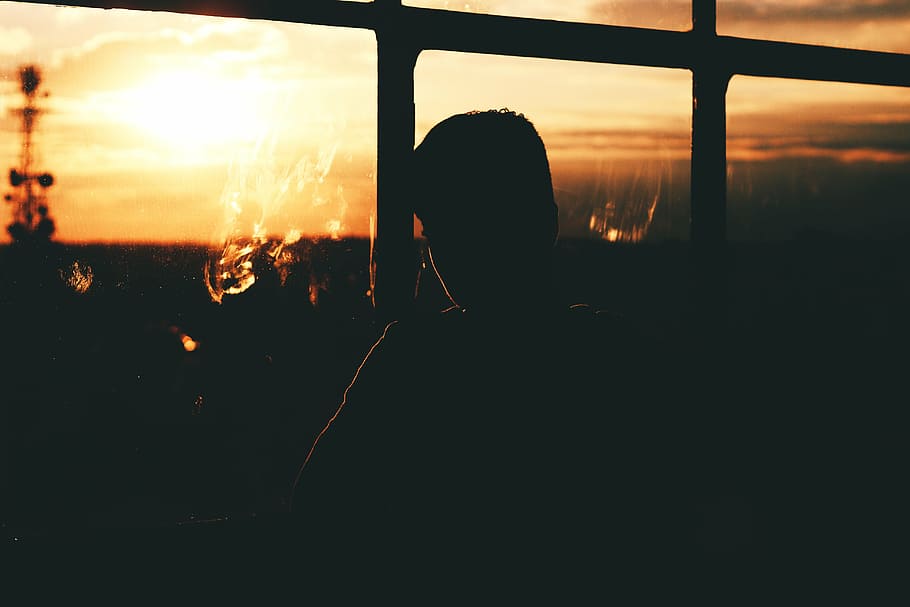 silhoutte photography, person, standing, window, silhouette, man, near, glass, pane, sunset
