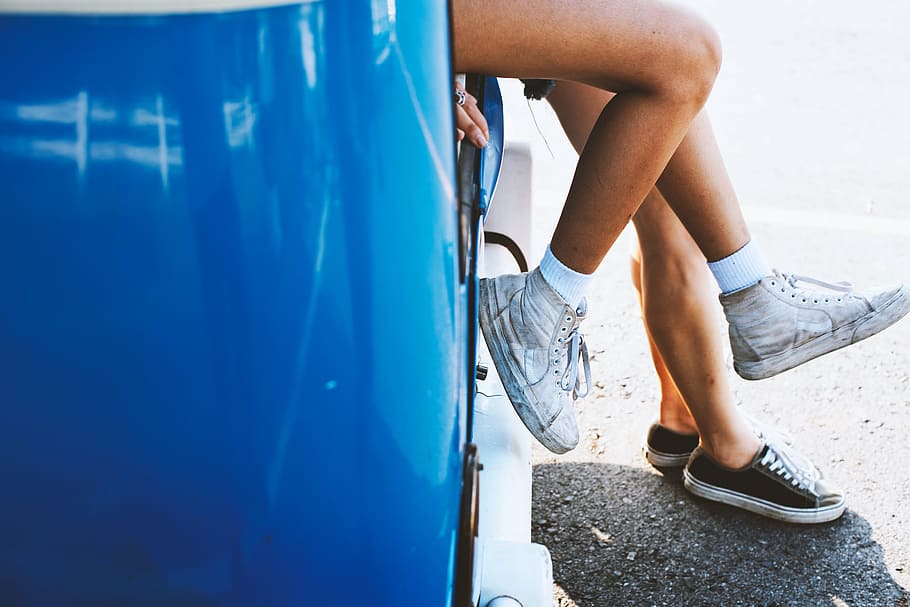 person, wearing, white, high-top sneakers, blue, car, vehicle, people, shoe, legs