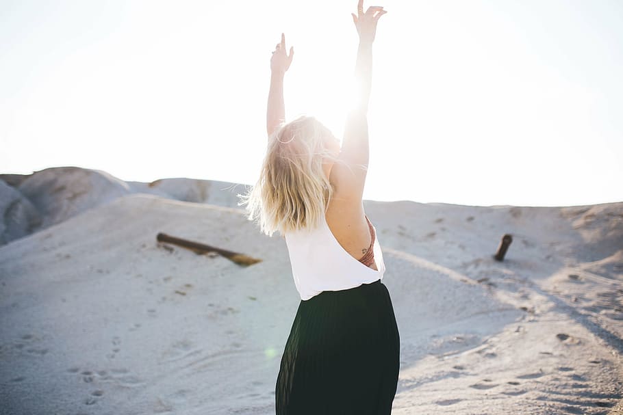 woman, raising, arms, sand dunes, daytime, wearing, white, top, black, skirt