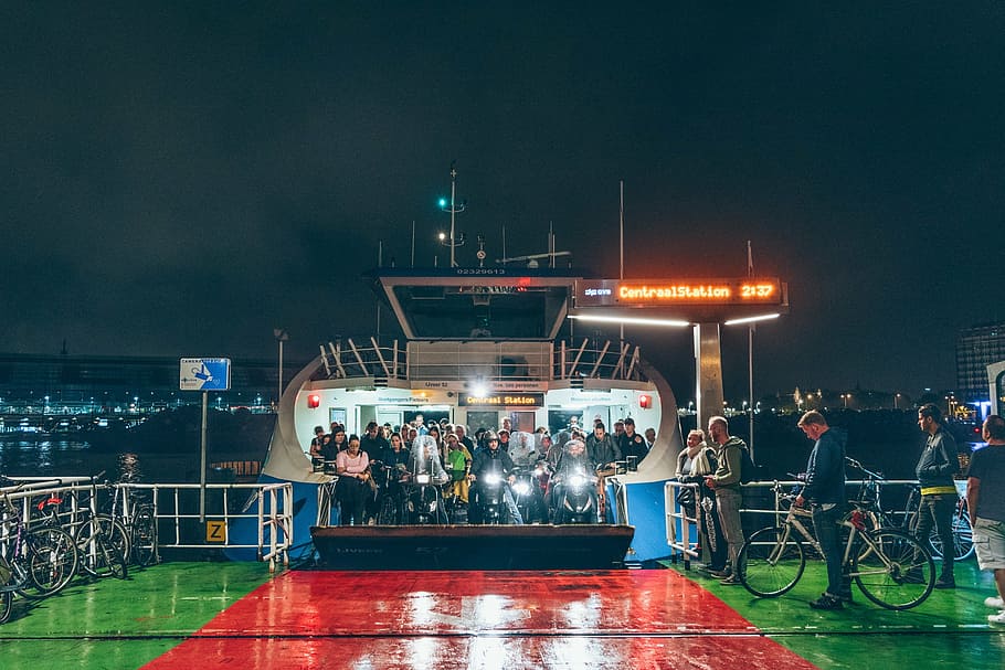 people, inside, cruiser boat, white, blue, ship, nighttime, crowd, night, light