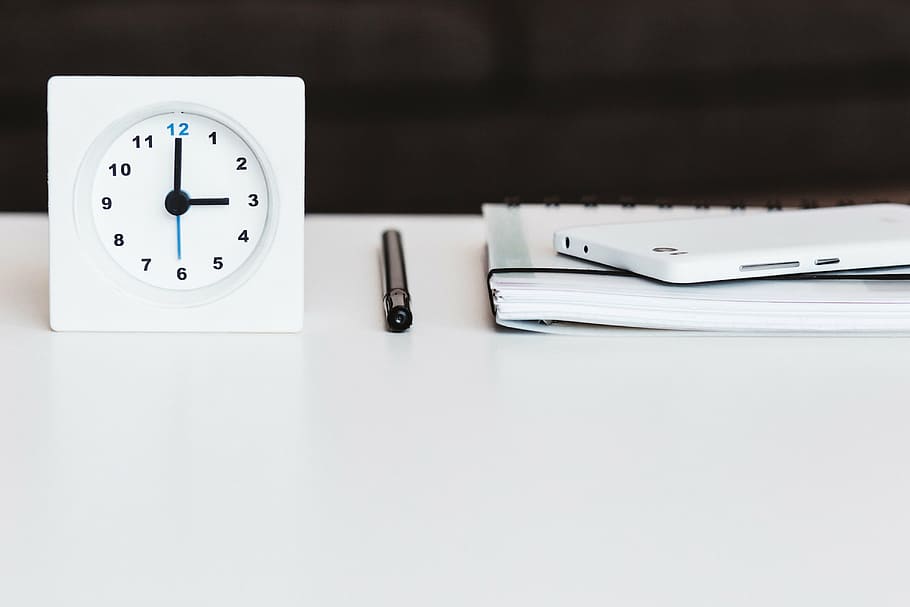 white, analog alarm clock, top, wooden, table, lifestyle, office, desk, clock, pen