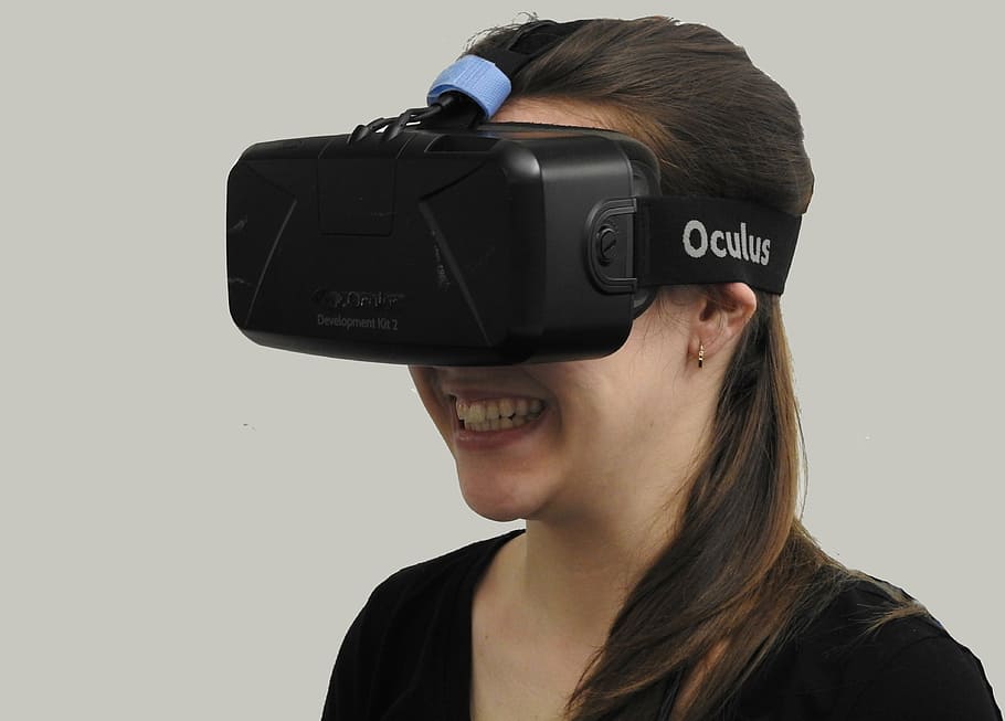 sorrindo, mulher, vestindo, preto, oculus, virtual, fone de ouvido da realidade, realidade virtual, tecnologia, realidade