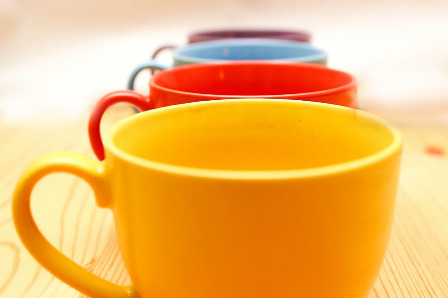 cup, glass, color, table, wood, wooden table, red, yellow, blue, black