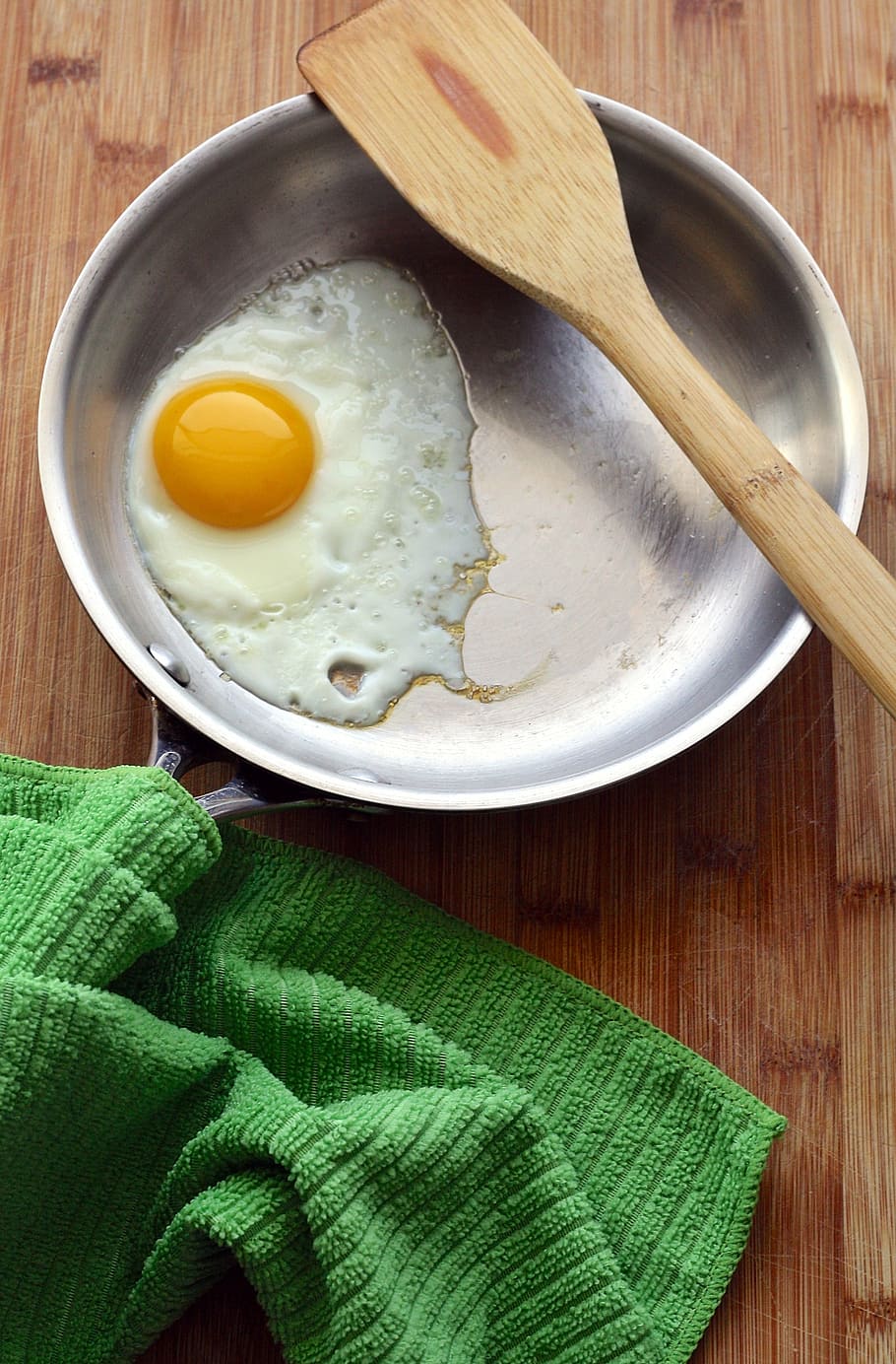 fried, egg, round, gray, frying, pan, brown, wooden, ladle, eggs