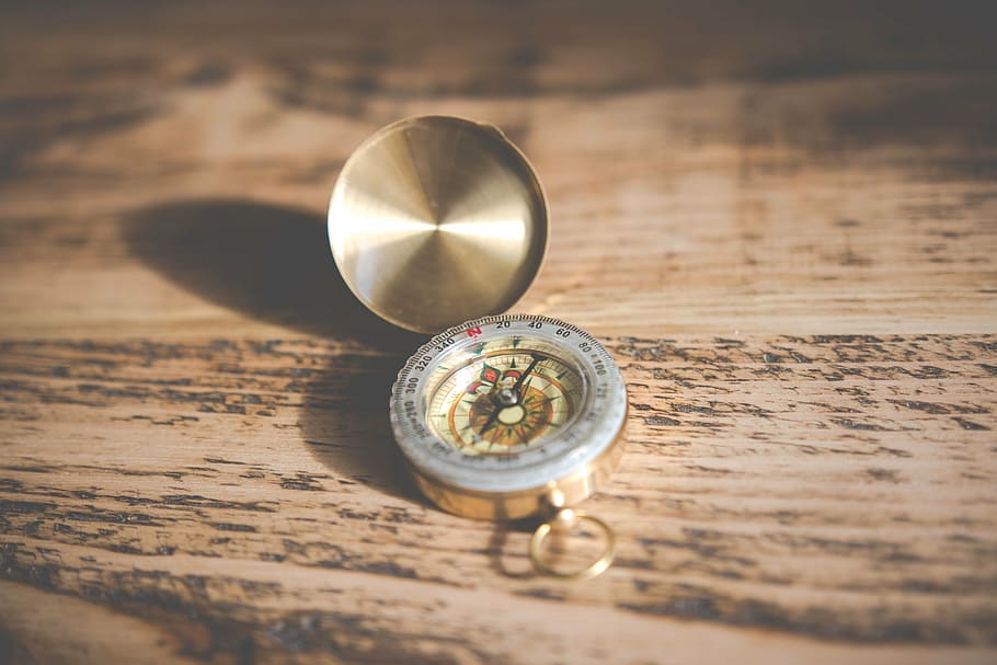 gold-colored compass, brown, wooden, surface, wood, table, compass, direction, discovery, north