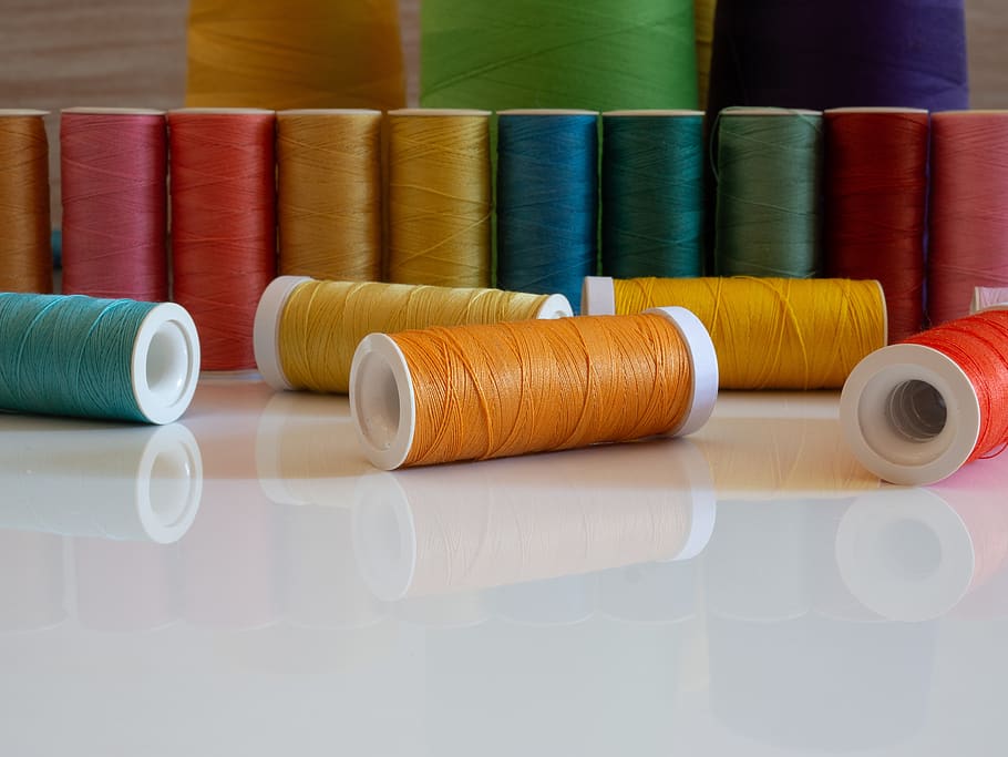 sewing, website background, copy space, front view, table top view, sewing threads, colorful threads, spool, bobbin, hobby