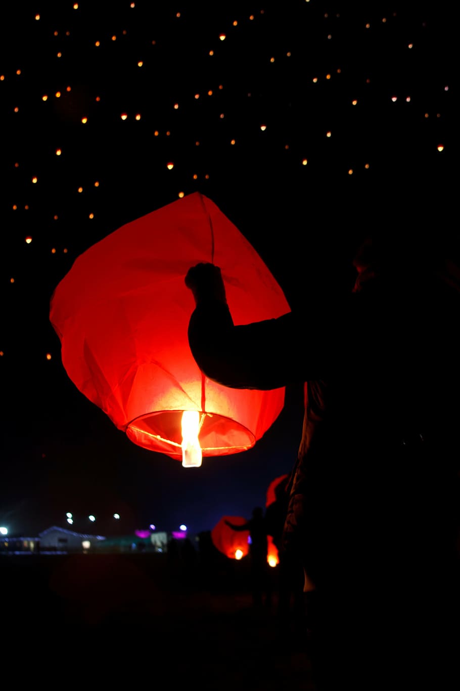 man, holding, lighted, sky lantern, night time, chinese, asian, candle, celebration, fire