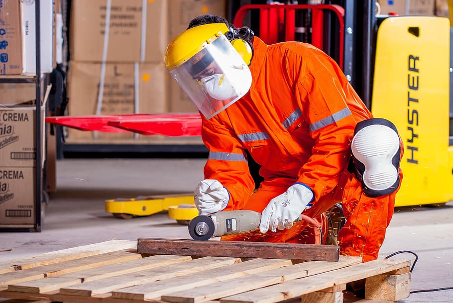man fixing wood, industrial, security, logistic, work clothes, industrial safety, protective goggles, vest, worker, mandatory