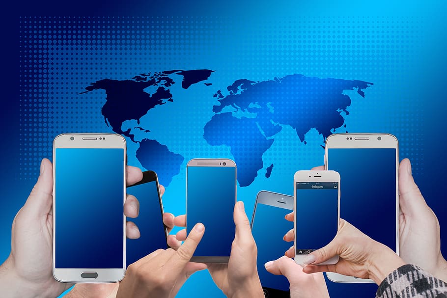 four assorted phones, digitization, electronic, smartphone, mobile phone, phone, hands, globe, continents, networking
