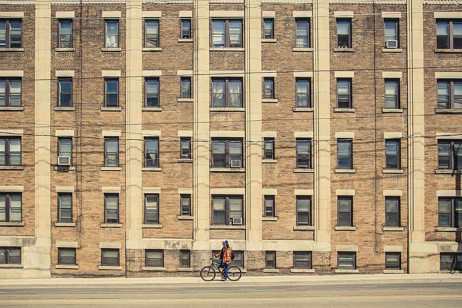person, bike, building, man, riding, bicycle, near, high, rise, architecture
