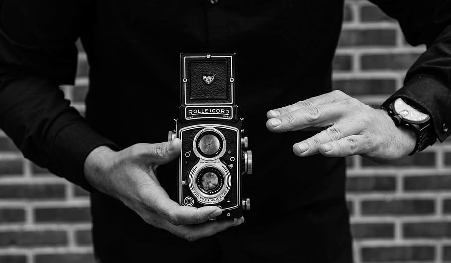 grayscale photo, person, holding, vintage, camera, man, rolleicord, watch, taking pictures, people