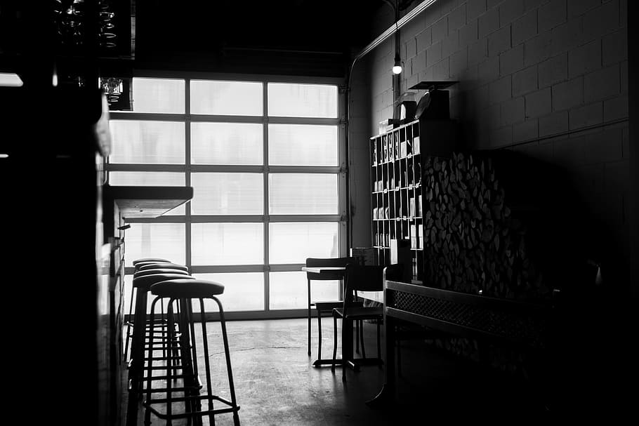 grayscale photo, bar counter, round barstools, bar, stools, garage, black and white, indoors, seat, chair