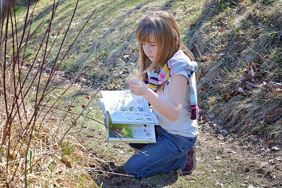 girl, writing, book, kneeling, grass, human, child, read, have a look, inquire about