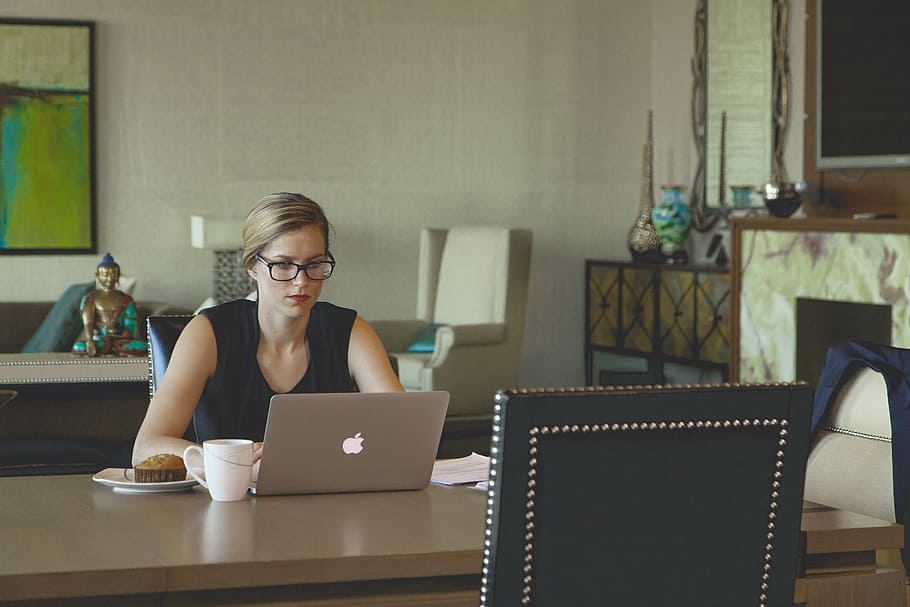 woman, wearing, black, sleeveless dress, sitting, front, silver macbook, laptop, coffee, breakfast