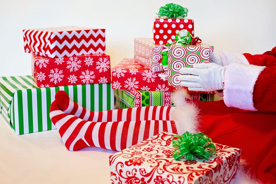person, wearing, red, white, santa dress, sitting, gifts, holding, green, present