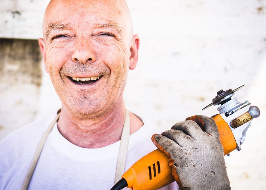 man, holding, brown, angle grinder, grinder, happy, industrial worker, person, smiling, one person