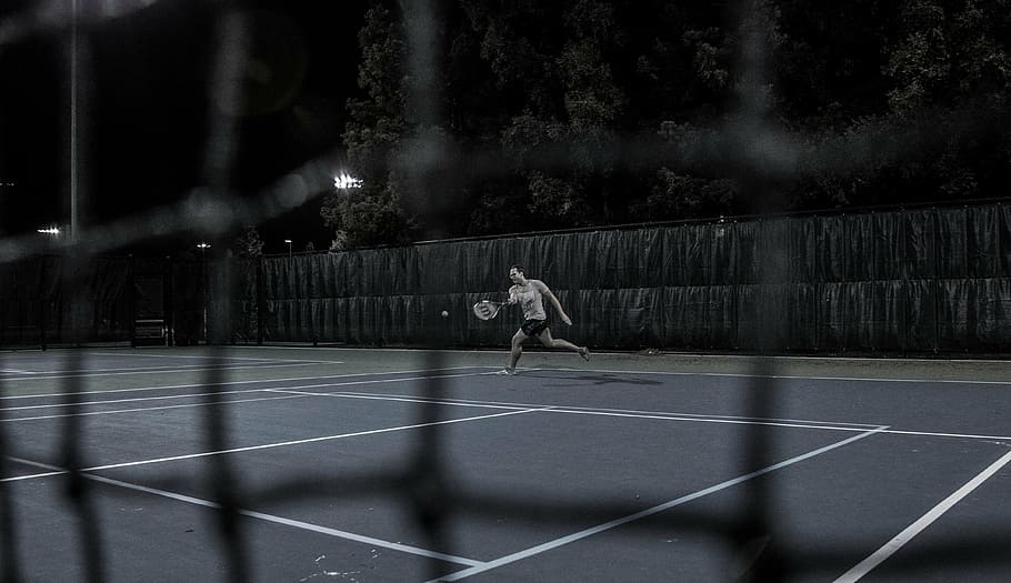 person, playing, tennis, outdoors, wearing, gray, shirt, holding, racket, night