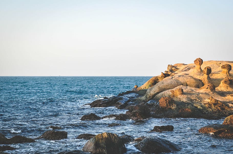 brown, rocks, sea, overlooking, horizon, daytime, boulders, near, body, water