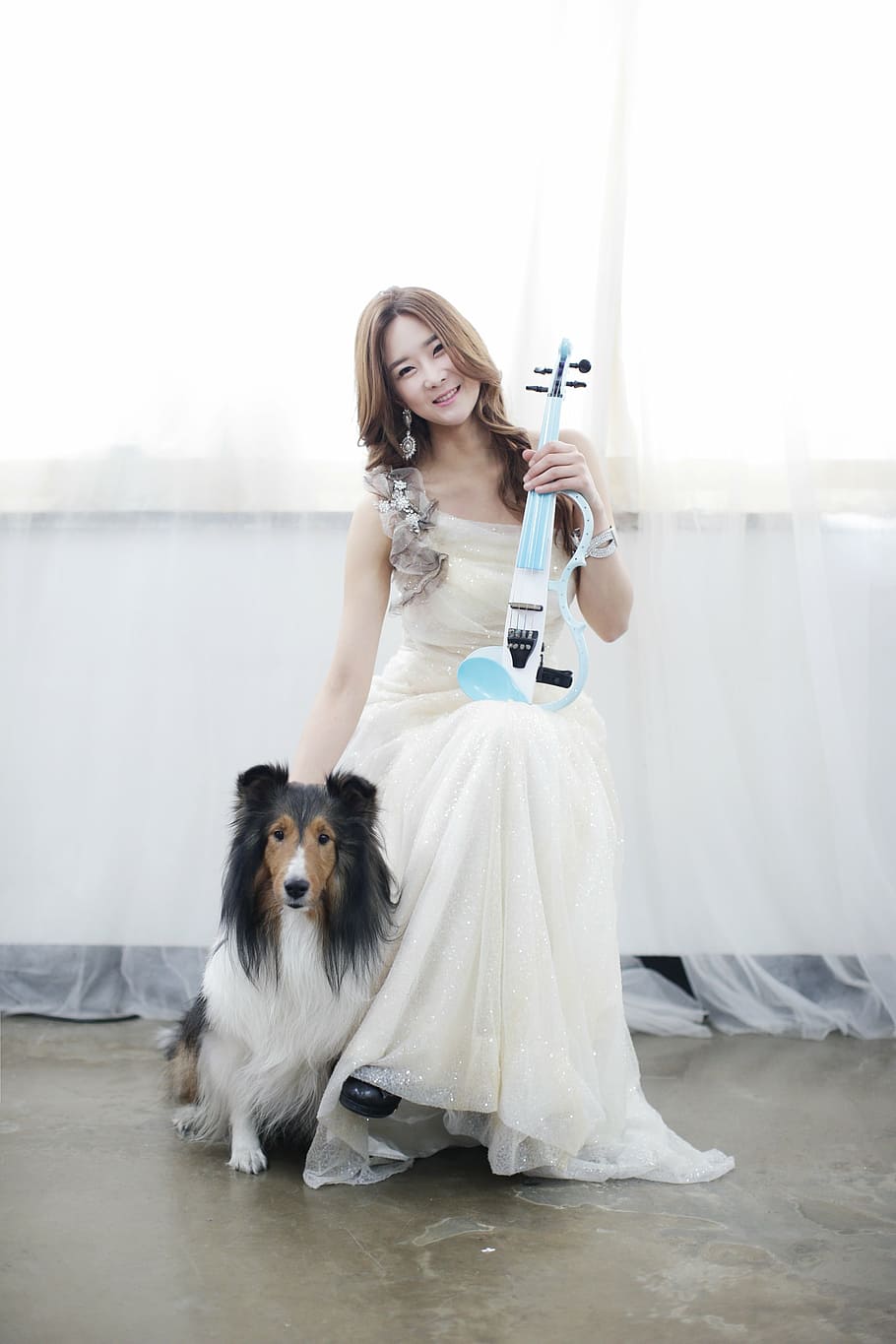 smiling, woman, holding, blue, string guitar, rough, collie, women's, violin, dog