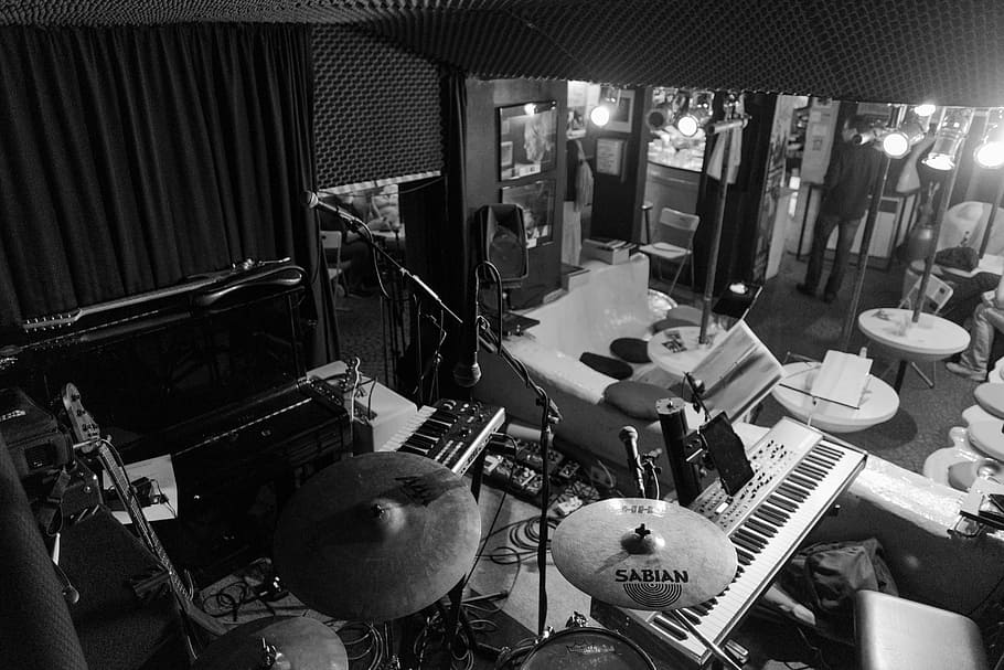 grayscale photo, drum, set, music room, stage, live, occurs, keyboard, guitar, bass