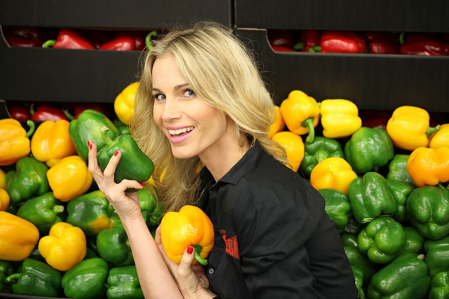 woman, wearing, black, collared, shirt, holding, green, peppers, vegetables, a healthy diet