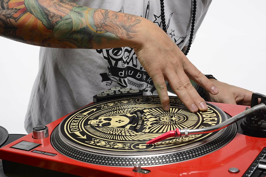 person spinning turntable, dj, turntable, scratch, hip hop, culture, hand, tattoos, music, one person