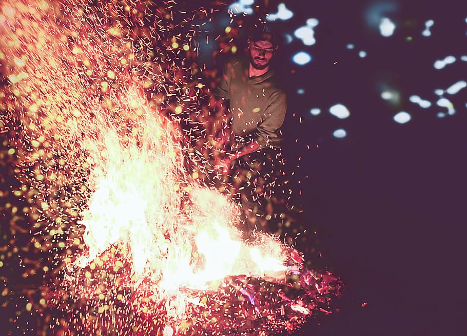 man, standing, front, bonfire, wearing, grey, jacket, nighttime, fire, lights