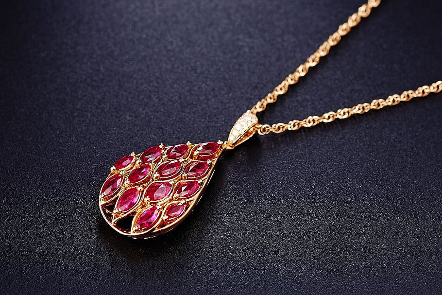 red, jeweled, gold-colored pendant necklace, jewelry, ruby, pendant, wealth, luxury, necklace, indoors