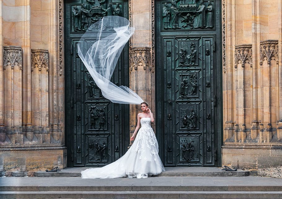 woman, wearing, wedding dress, standing, front, brown, black, building, wedding veil, floating