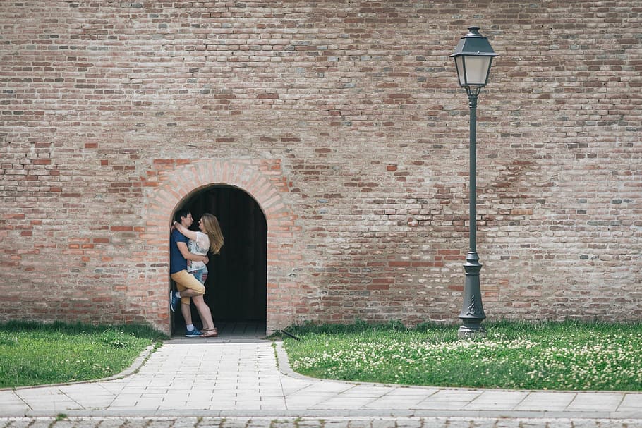 man, woman, standing, door, light post, hugging, inside, arch, shape, alley