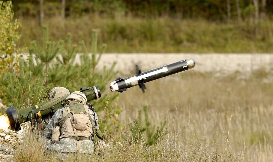 focus photo, person, firing, rpg, daytime, anti tank guided missile, rocket, anti tank missile, missile launch, weapon