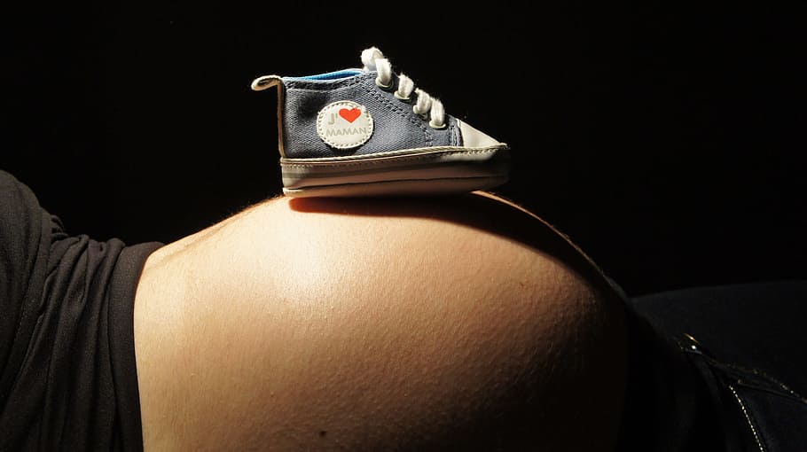 unpaired, baby, blue, high-top crib shoe, woman, Speaker, Belly, Shoe, Mom, black background