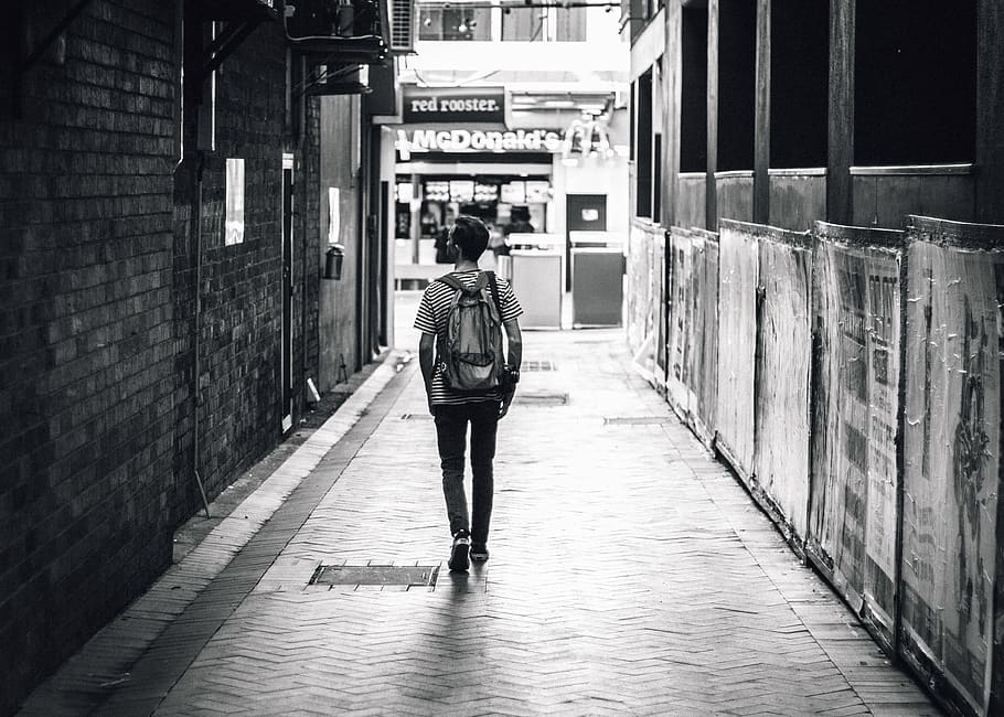 grayscale photo, man, walking, pavement, towards, mcdonalds, people, adult, street, black and white