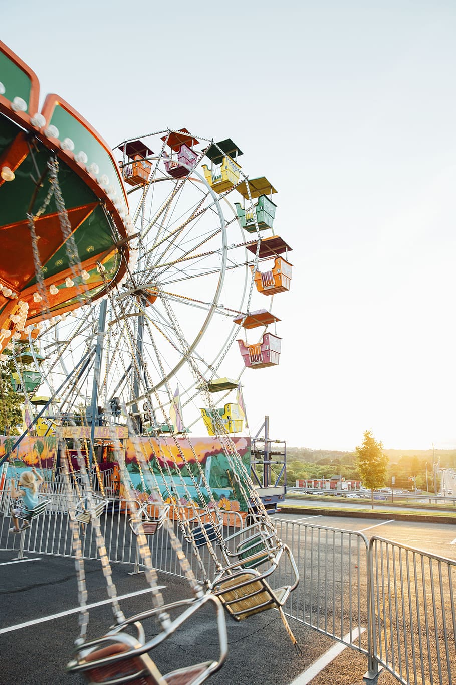 ferris wheel, amusement park, architecture, infrastructure, structure, sun, amusement park ride, arts culture and entertainment, sky, fairground