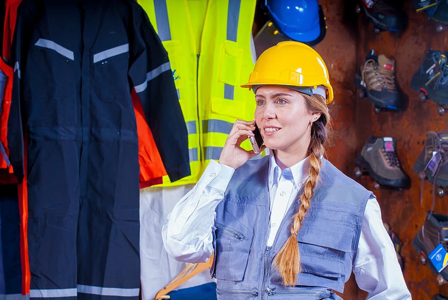 woman, wearing, yellow, hard, hat, holding, smartphone, helmet, industrial, security