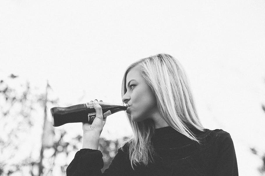 greyscale photography, woman, sweater drinking coca-cola, bottle, daytime, greyscale, photography, sweater, drinking, coca-cola