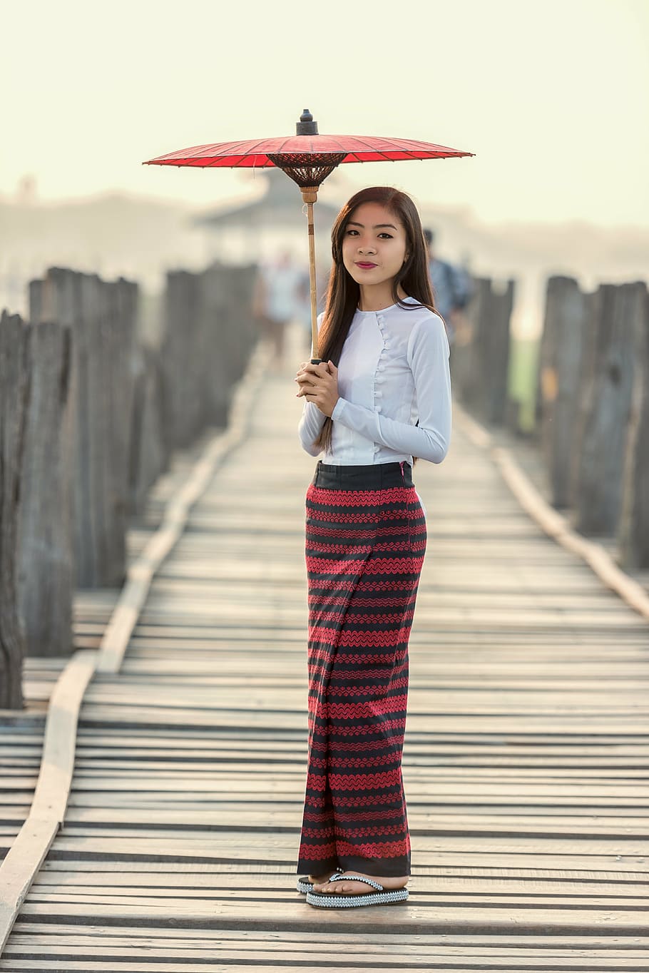 focus photography, woman, standing, bridge, wearing, white, long-sleeved, shirt, holding, oil umbrella