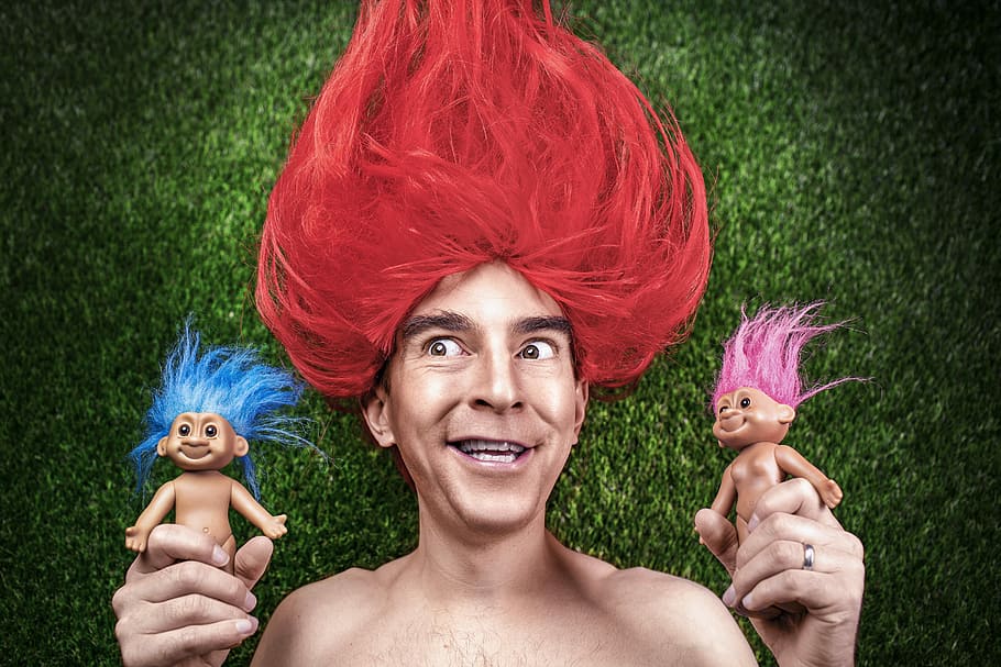 person, red, hair, holding, two, troll toys, red hair, troll, toys, people