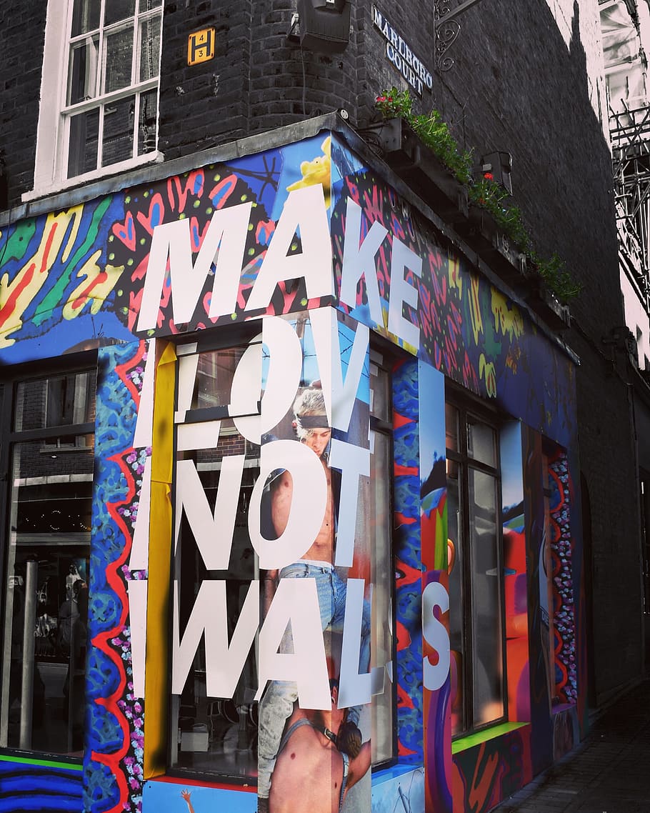 wall, corner shop, advert, slogan, building exterior, architecture, built structure, graffiti, multi colored, creativity