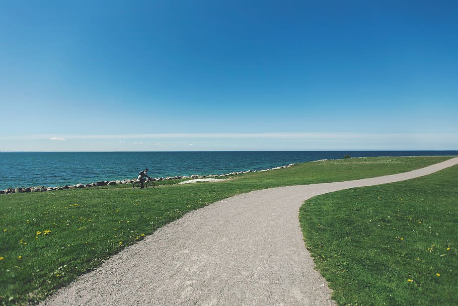 gray, pathway, body, water, person, riding, bike, near, sea, gravel