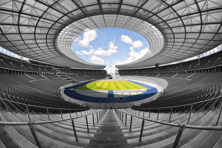 fish-eye view photograph, football stadium, olympic stadium, berlin, 1936, symmetrical, interior, color key, extreme long shot, architecture