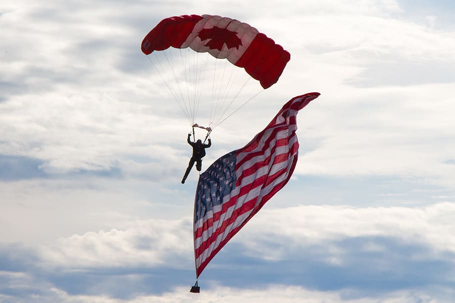 person, gliding, midair, skydiver, usa flag, canadian, airshow, wetaskiwin, alberta, canada