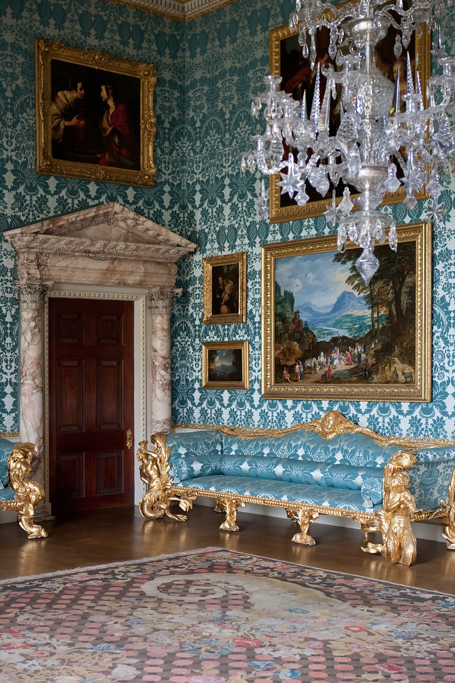 salon, elegant, blue silk, wall covering, upholstery, marble door surround, pediment, gilt, crystal chandelier, mahogany door